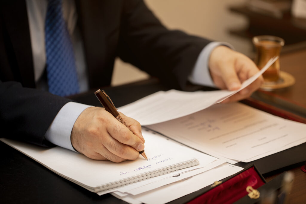 businessman signing important contract papers businessman signing important contract papers